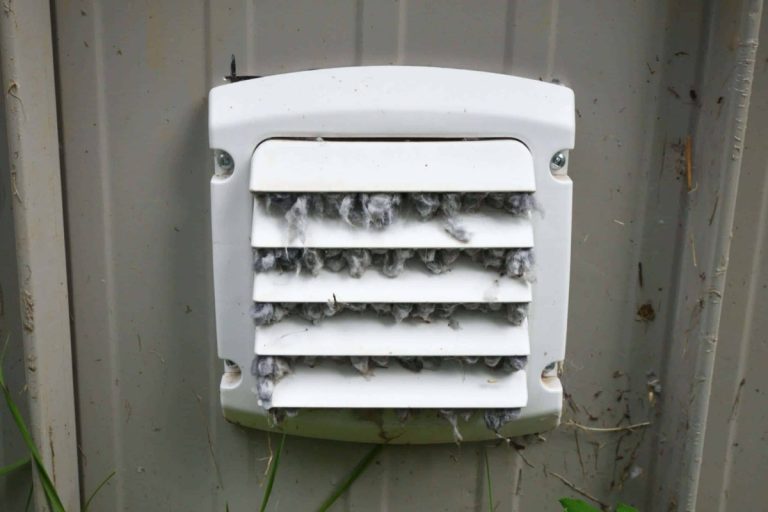 Exterior dryer vent cover packed with lint before cleaning, dryer vent cleaning for Charlotte, NC homes from Smoke Alert