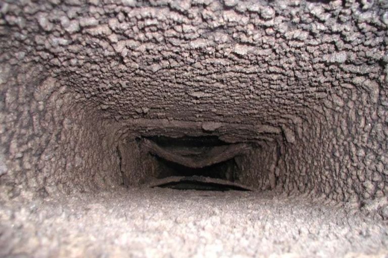 Dryer vent duct lined with gray lint buildup, home fire safety services in Mecklenburg County, NC by Smoke Alert