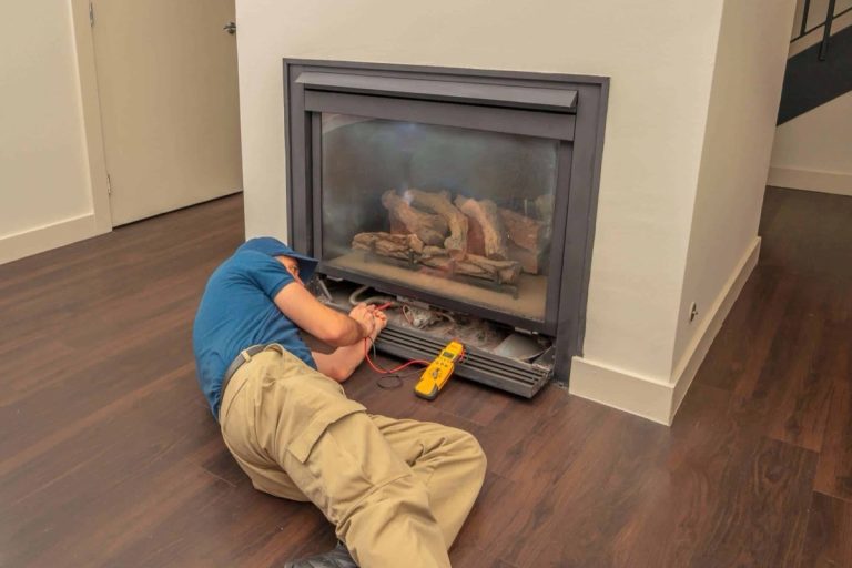 Technician installing a new gas fireplace insert, fireplace installation in Charlotte, NC by Smoke Alert